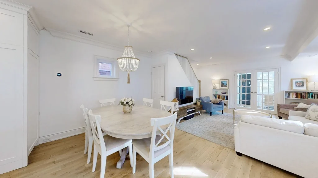 Open-concept dining and living room with white oak floors