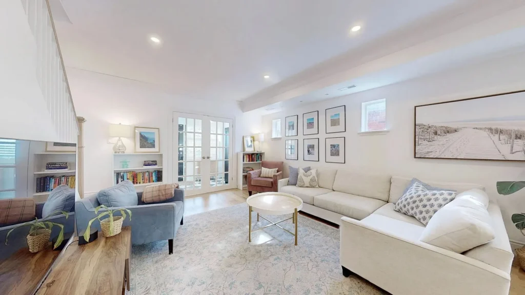 Living room with cream sectional sofa and French doors
